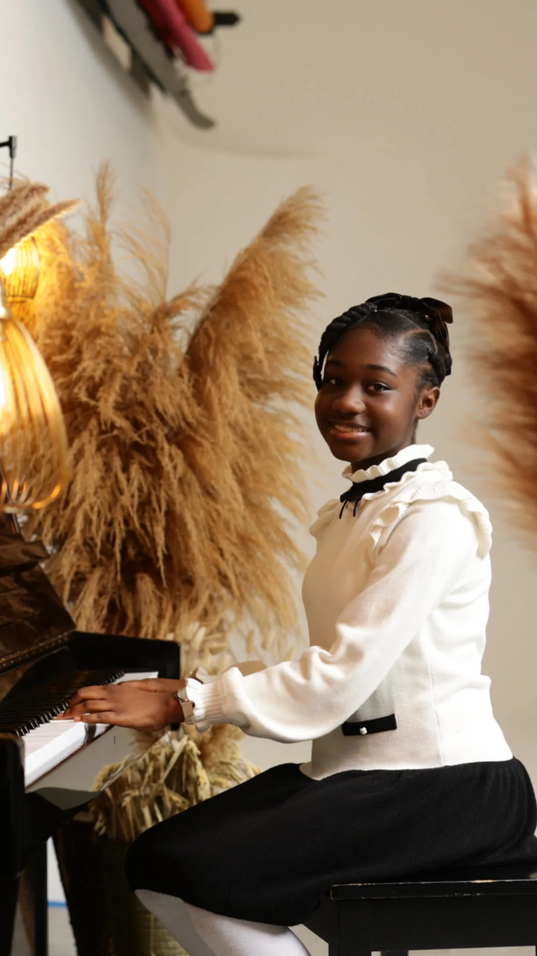 Abigail Samson smiling while seated at a piano