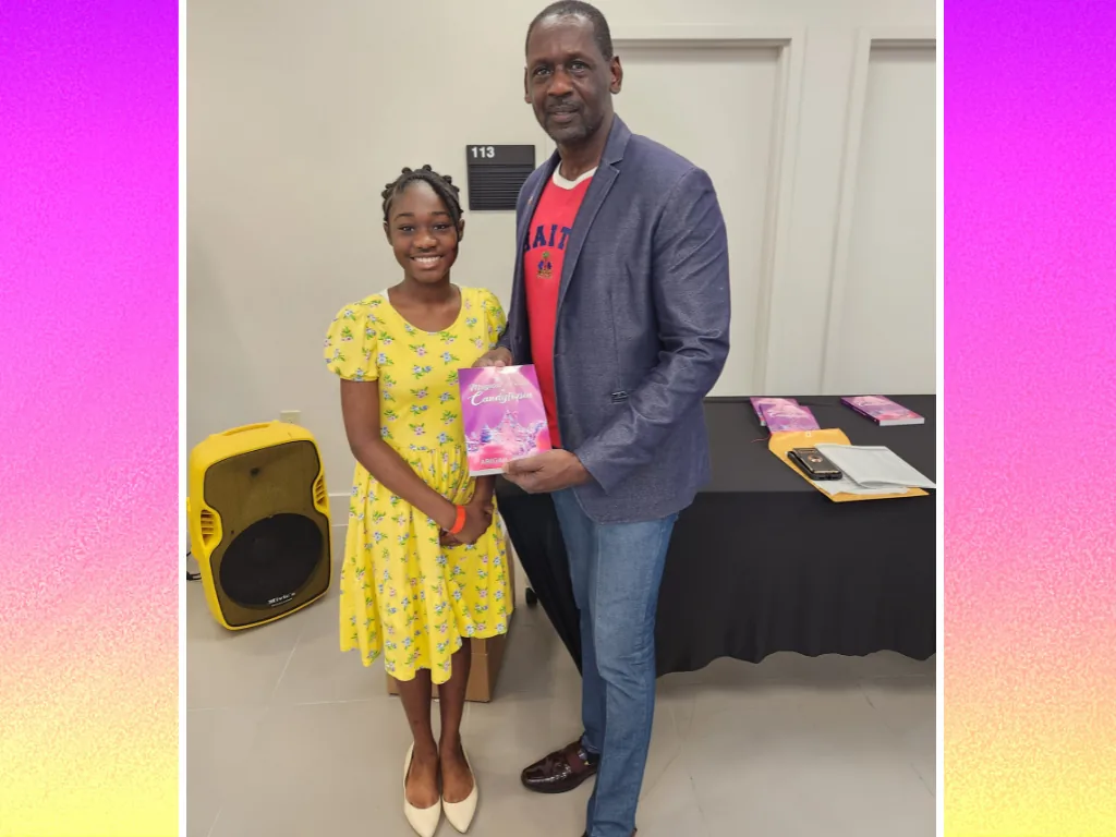 A guest holds a copy of The Magical World of Candytopia with Abigail Samson