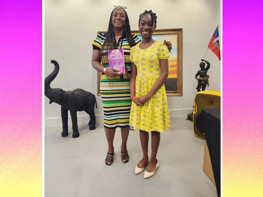 Abigail Samson with a guest holding Candytopia at a community celebration