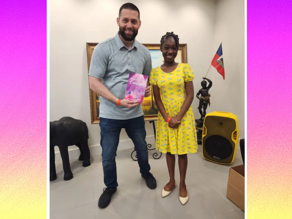 A reader posing with Abigail Samson and a copy of Candytopia
