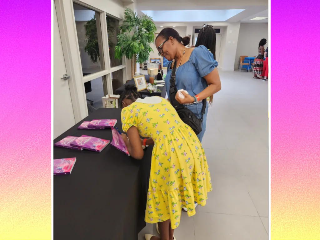 A reader visits the Candytopia book table during a community event